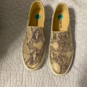 “Restricted” snake skin slip ons